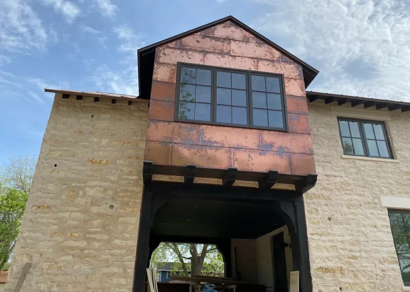 Copper metal panel facade on a stone building for Skylight Installation in Allen
